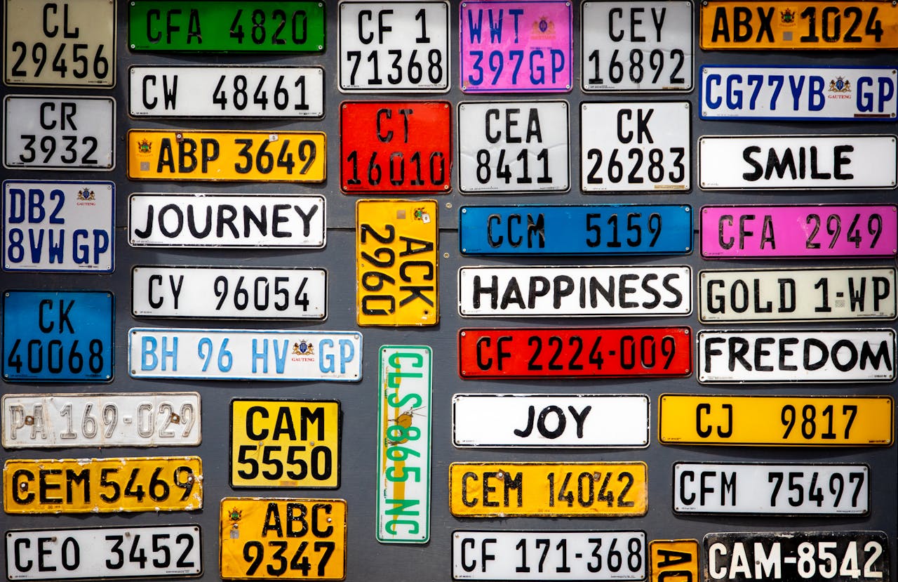 A vibrant display of assorted vintage license plates with inspirational words.